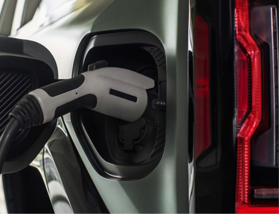Close up of charging port with charger plugged in on a GMC Hummer EV SUV - Marmie GMC in GREAT BEND KS